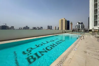 a swimming pool on the roof of a building at Tranquil 1Bedroom in Binghatti Gardenia in Dubai