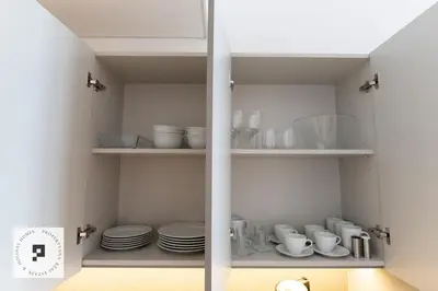 a cupboard with plates and cups and dishes in it at Affordable New Studio I MAG 980 I Summer Deal in Dubai