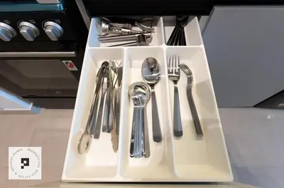 a white tray with silver utensils on a table at Affordable New Studio I MAG 980 I Summer Deal in Dubai