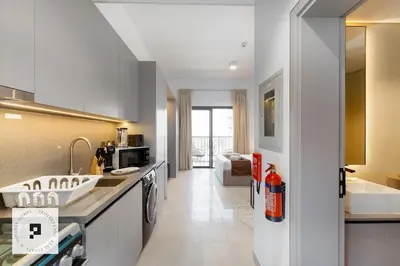 a kitchen with a sink and a counter top at Affordable New Studio I MAG 980 I Summer Deal in Dubai