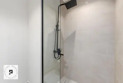 a shower with a glass door in a bathroom at Affordable New Studio I MAG 980 I Summer Deal in Dubai