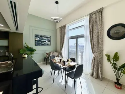a dining room with a table and a large window at Luxury Apt Near Burj & Metro in Dubai