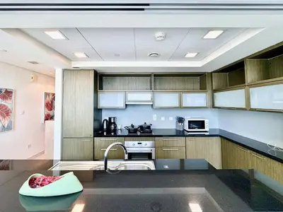 a kitchen with a sink and a stove top oven at Luxury Apt Near Burj & Metro in Dubai