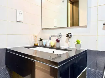 a bathroom with a sink and a mirror at Luxury Apt Near Burj & Metro in Dubai