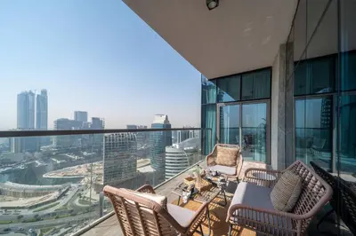 a balcony with chairs and a table on a building at Frank Porter - MADA Residences, Downtown in Dubai