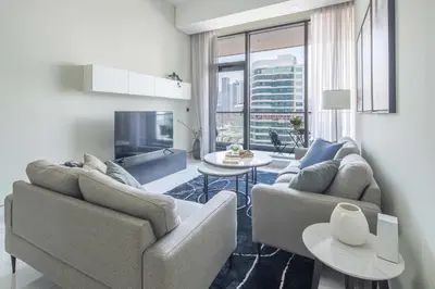 a living room with two couches and a tv at Frank Porter - J One Tower, Buisness Bay in Dubai