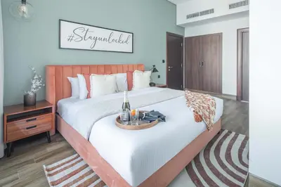a bedroom with a large bed with a tray on it at Frank Porter - J One Tower, Buisness Bay in Dubai
