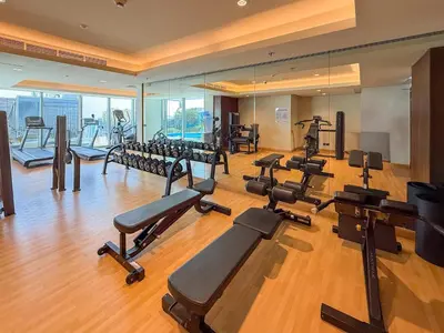 a gym with a bunch of treadmills and machines at Frank Porter - J One Tower, Buisness Bay in Dubai
