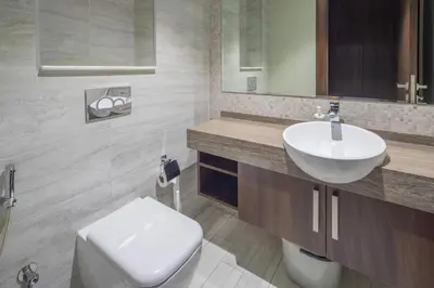 a bathroom with a white toilet and a sink at Frank Porter - J One Tower, Buisness Bay in Dubai