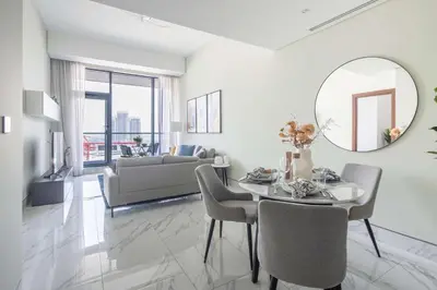 a living room with a table and a mirror at Frank Porter - J One Tower, Buisness Bay in Dubai