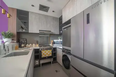 a kitchen with a stove and a washer and sink at Frank Poretr - MBL Royal, Jumeirah Lakes Towers in Dubai