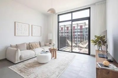 a living room with a couch and a large window at Frank Porter - Kensington Waters, Sobha Hartland in Dubai