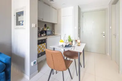 a kitchen with a table and chairs in a room at Frank Porter - Zada Tower in Dubai