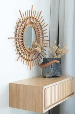 a mirror on top of a wooden shelf with a vase at Frank Porter - Binghatti Tulip in Dubai