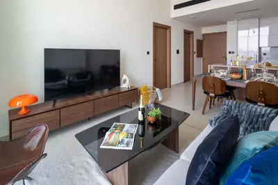a living room with a large flat screen tv at Frank Porter - Binghatti Tulip in Dubai