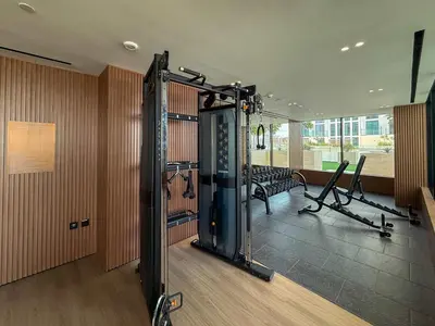 a large room with a gym with a simulator at Frank Porter - Binghatti Tulip in Dubai