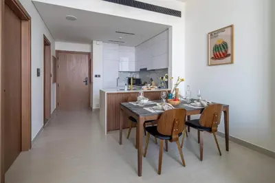a kitchen and dining room with a table and chairs at Frank Porter - Binghatti Tulip in Dubai