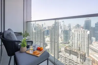 a tray of food on a table in a room with a window at Frank Porter - Grande Signature Residences in Dubai