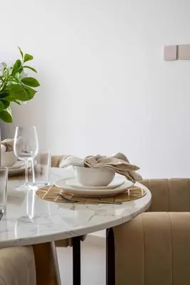 a dining room table with plates and wine glasses at Frank Porter - Grande Signature Residences in Dubai