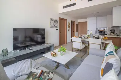 a living room with a couch and a table at Frank Porter - Binghatti Amber in Dubai