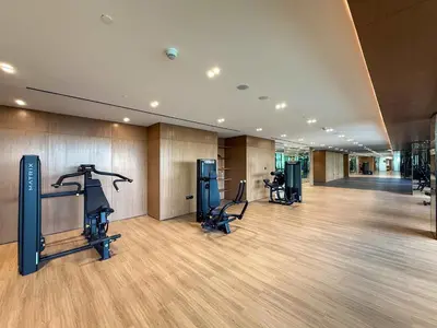 a gym with treadmills and exercise equipment in a building at Frank Porter - Binghatti Amber in Dubai