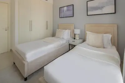 two beds sitting next to each other in a bedroom at Frank Porter - Burj Crown in Dubai