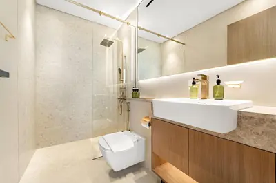 a bathroom with a sink and a toilet and a shower at VayK - Cozy Stylish 1BR in JVC in Dubai
