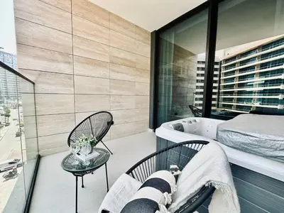 a bedroom with a bathtub and a bed and a bath tub at Artful Canal Escape With Jacuzzi And City Views! in Dubai