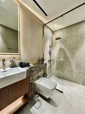 a bathroom with a sink and a shower and a toilet at Artful Canal Escape With Jacuzzi And City Views! in Dubai