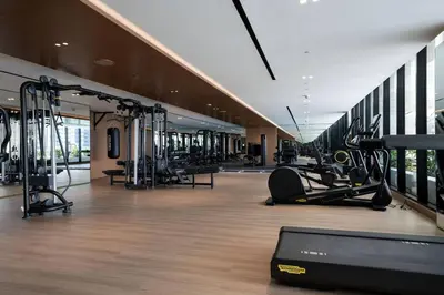 a gym with treadmills and cardio equipment in a building at Artful Canal Escape With Jacuzzi And City Views! in Dubai