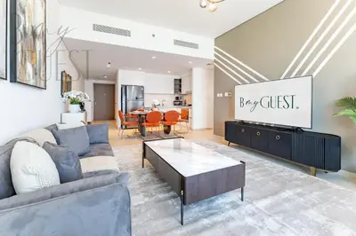 a living room with a couch and a table at Spice of Sophistication in a 2BR Downtown Views II in Dubai