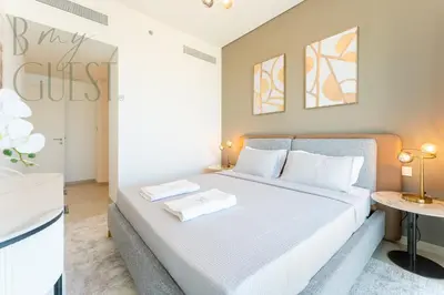 a bedroom with a bed with two towels on it at Spice of Sophistication in a 2BR Downtown Views II in Dubai