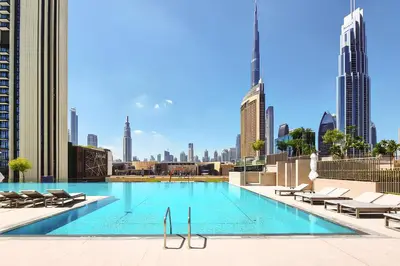 a swimming pool with a view of the city at Spice of Sophistication in a 2BR Downtown Views II in Dubai