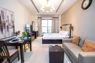 a hotel room with a bed and a living room at Elite Haven, Elegant Escape in Dubai - Free Pool in Dubai