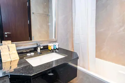 a bathroom with a sink and a mirror at Elite Haven, Elegant Escape in Dubai - Free Pool in Dubai