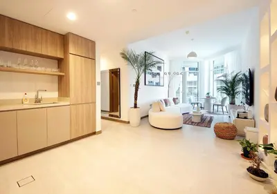 a living room with a couch and a table at Urban Oasis 2BR Retreat in Dubai with Pool View in Dubai