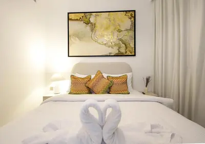 a bedroom with a bed with two white swans at Urban Oasis 2BR Retreat in Dubai with Pool View in Dubai