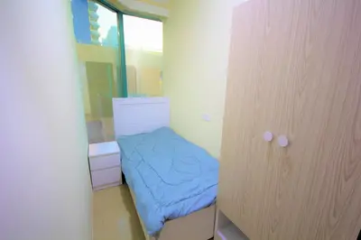 a small room with a bed and a mirror at Must update to luxury studio in heart of marina Dubai in Dubai