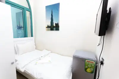 a small room with a bed and a window at Must update to luxury studio in heart of marina Dubai in Dubai