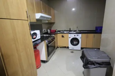 a kitchen with a washing machine and a washer at Must update to luxury studio in heart of marina Dubai in Dubai