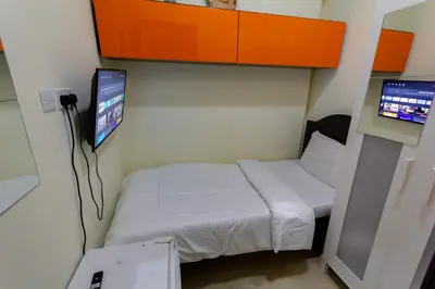 a small room with a bed and a tv at Must update to luxury studio in heart of marina Dubai in Dubai