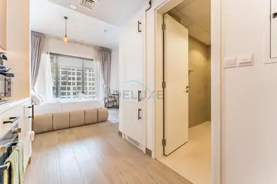 a bedroom with a bed and a large window at Steps Away from Town Square Park Studio, Minutes Drive to Butterfly Garden, Liva Apartments, Town Square by Deluxe Holiday Homes in Dubai
