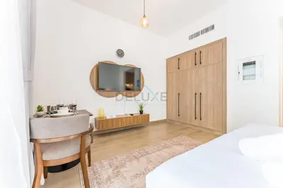 a bedroom with a bed and a sink and a mirror at Steps Away from Town Square Park Studio, Minutes Drive to Butterfly Garden, Liva Apartments, Town Square by Deluxe Holiday Homes in Dubai