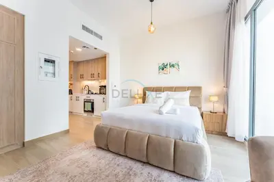 a bedroom with a large white bed and a couch at Steps Away from Town Square Park Studio, Minutes Drive to Butterfly Garden, Liva Apartments, Town Square by Deluxe Holiday Homes in Dubai