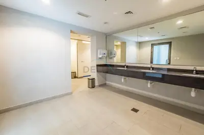 a bathroom with two sinks and a large mirror at Steps Away from Town Square Park Studio, Minutes Drive to Butterfly Garden, Liva Apartments, Town Square by Deluxe Holiday Homes in Dubai