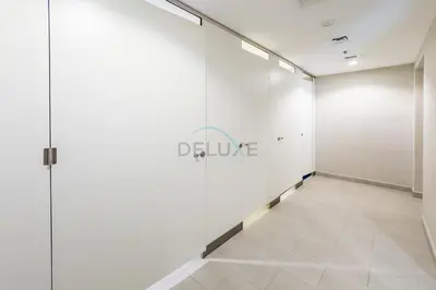 a hallway with white walls and a tile floor at Steps Away from Town Square Park Studio, Minutes Drive to Butterfly Garden, Liva Apartments, Town Square by Deluxe Holiday Homes in Dubai