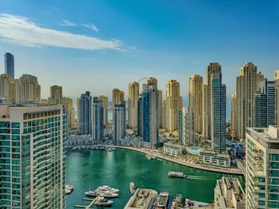 a view of a city with boats in the water at Tratoli JBR Shared Hostel with Sea View in Dubai