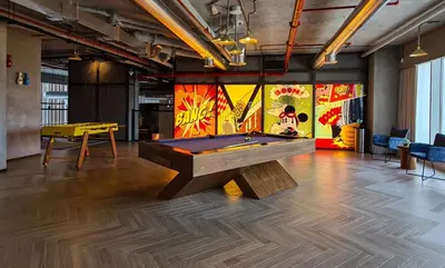 a ping pong table in a room with a pool table at Chic 1BR With Balcony in Collective 2 Dubai Hills in Dubai