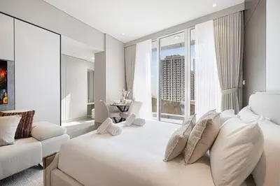 a bedroom with a large white bed and a large window at LUXE Rooftop Infinity Pool 5 Mins to JBR Dubai Marina View in Dubai