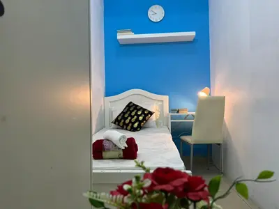 a bedroom with a bed with a clock on the wall at Solo Cabin Room in Tecom Barsha Heights in Dubai